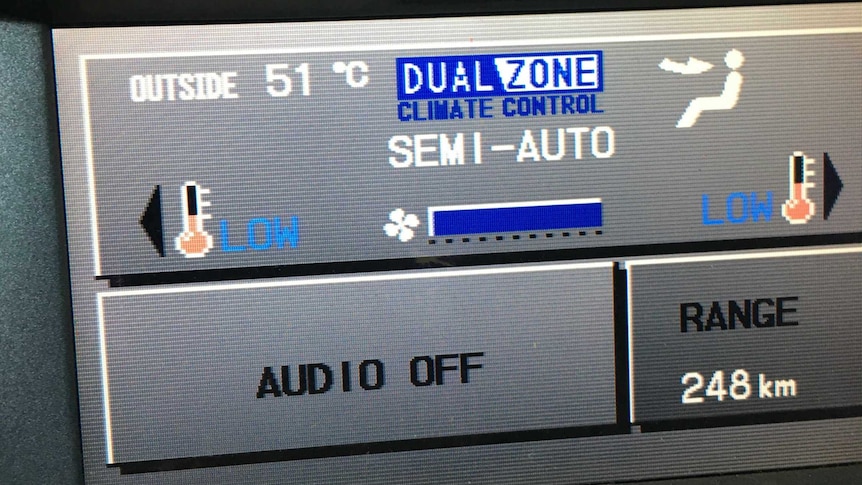A digital display of a car showing the outside temperature in 51 degrees Celsius