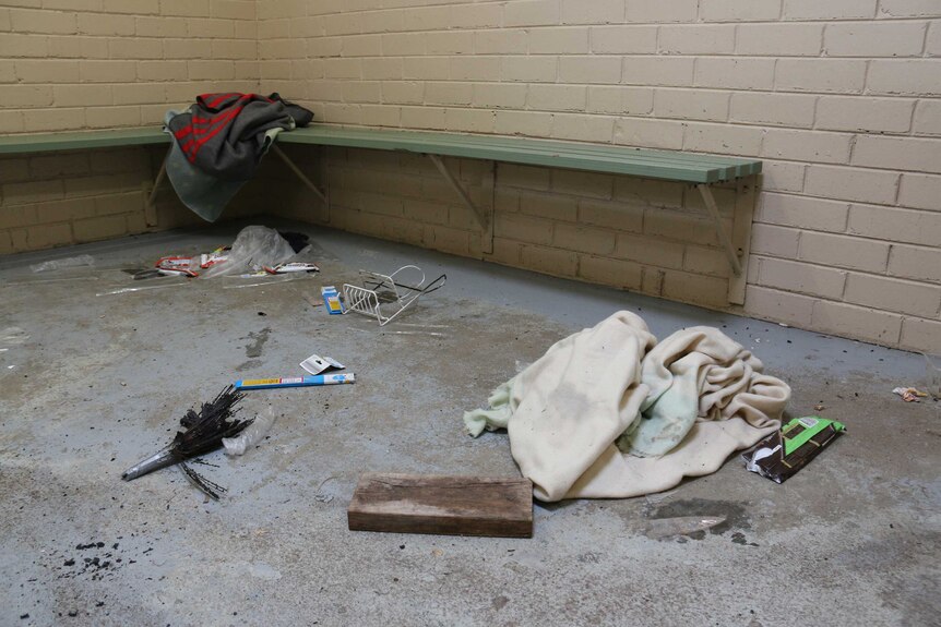 Rubbish and blankets on the floor of a public toilet block in Rosebud where some homeless people sleep.