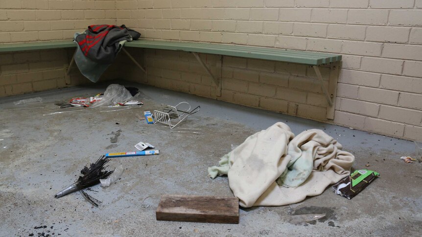 Rubbish and blankets on the floor of a public toilet block in Rosebud where some homeless people sleep.