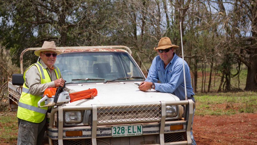 BlazeAid volunteer Dennis Bishop and farmer Jon Chaseling lean over a ute.