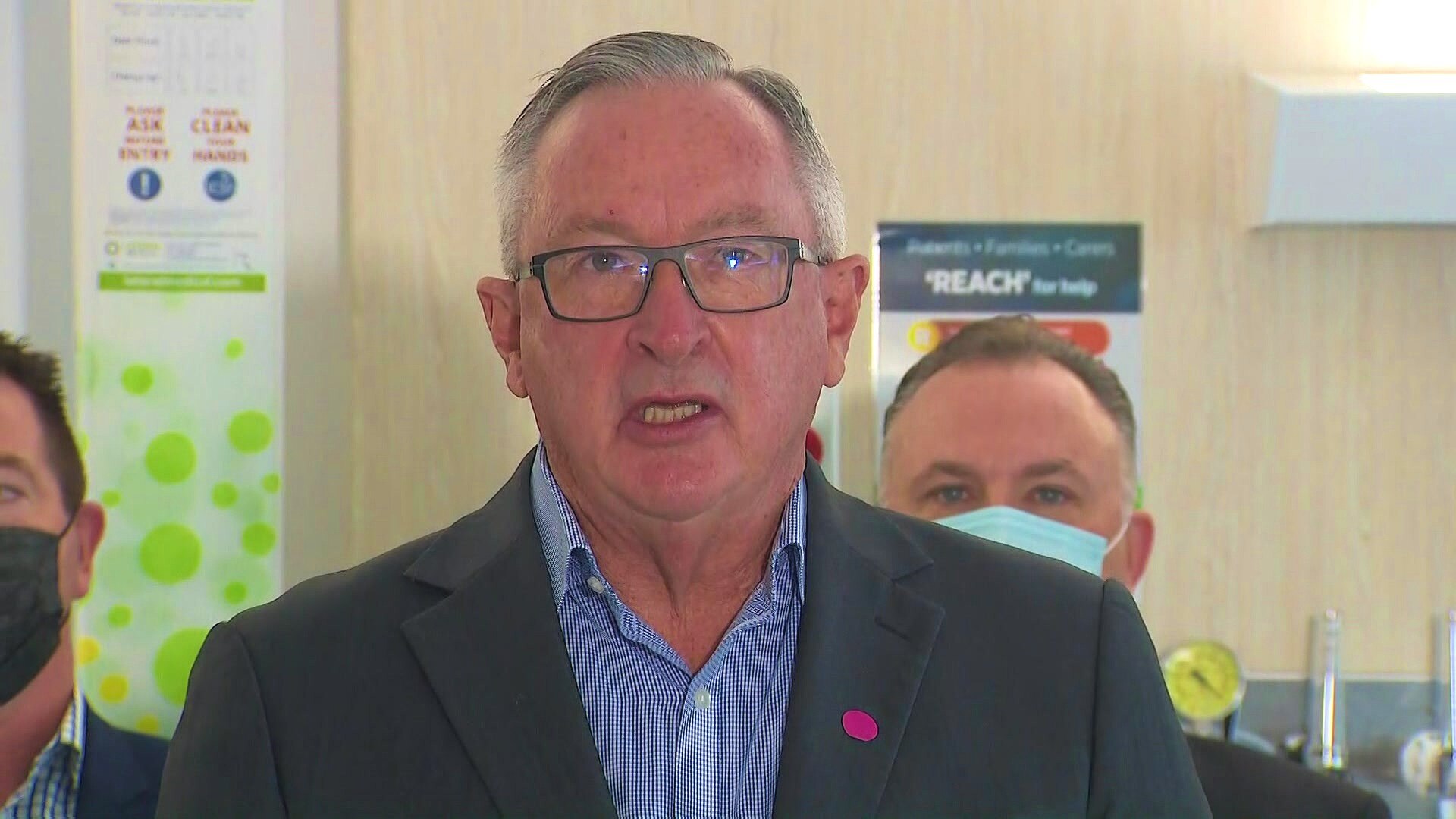 a man wearing glasses talking