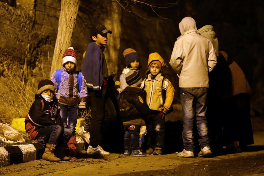 Children in the Syrian town of Madaya wait for food aid to arrive.
