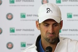 Novak Djokovic looks miserable after being knocked out of French Open