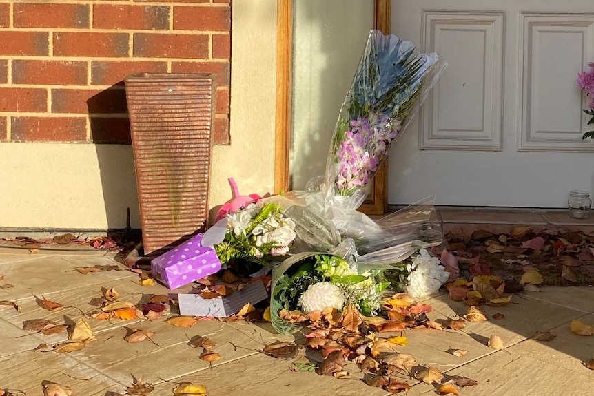 Flowers and cards in front of a door