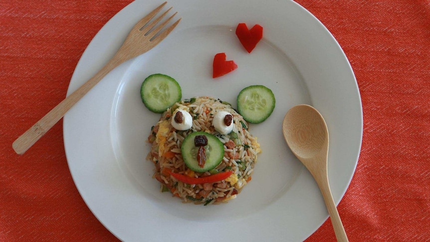 Fried rice on a plate with toppings to make it look like a teddy bear