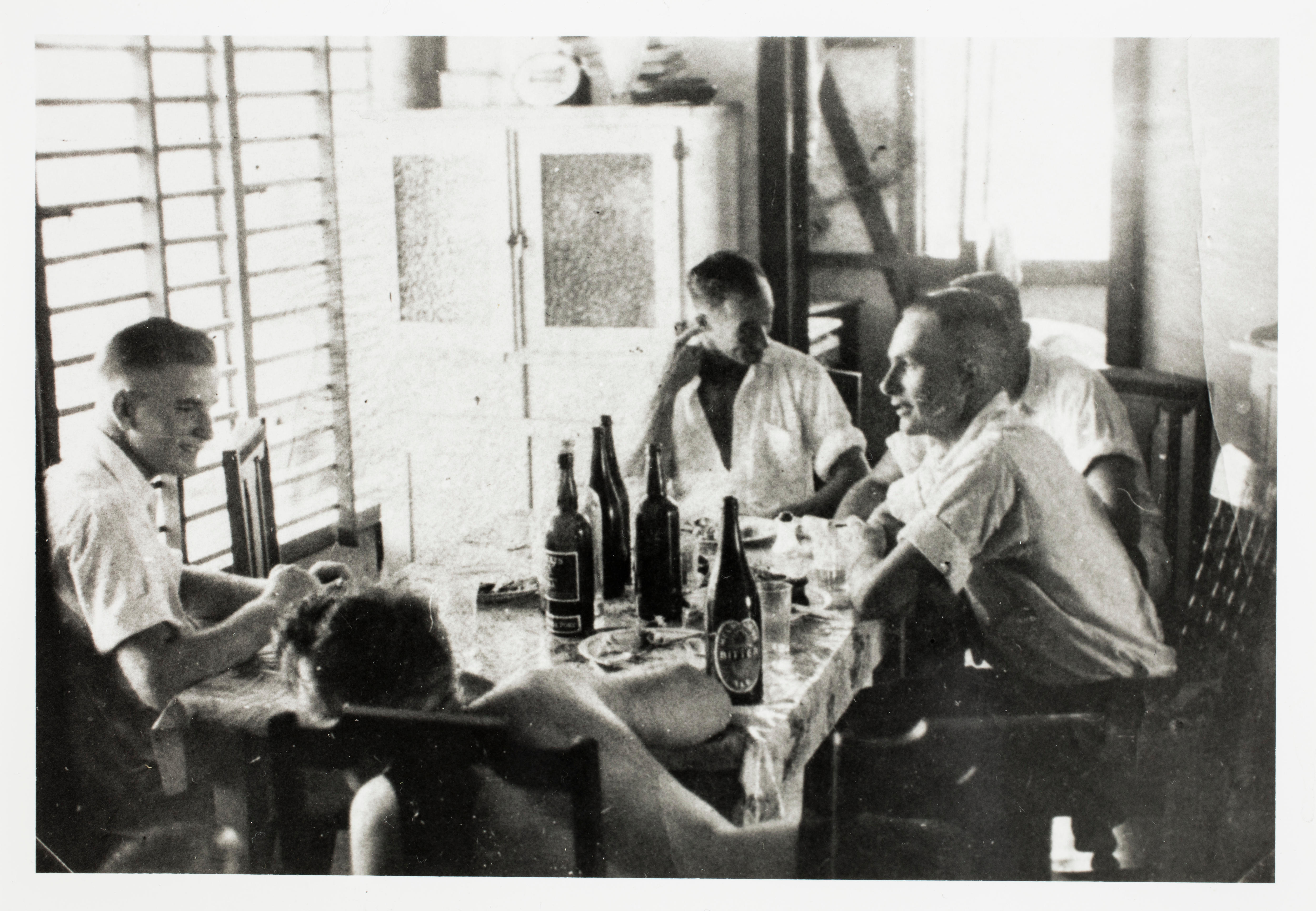 Black and white photo of men relaxing 