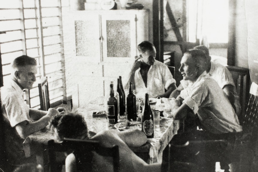 Black and white photo of men relaxing 