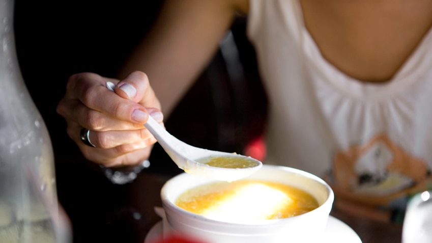 Eating hot soup from a plastic bowl