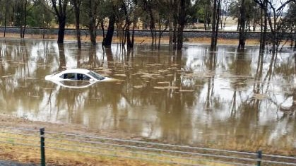 A car trapped in floodwaters near the Hume Freeway north of Wangaratta.