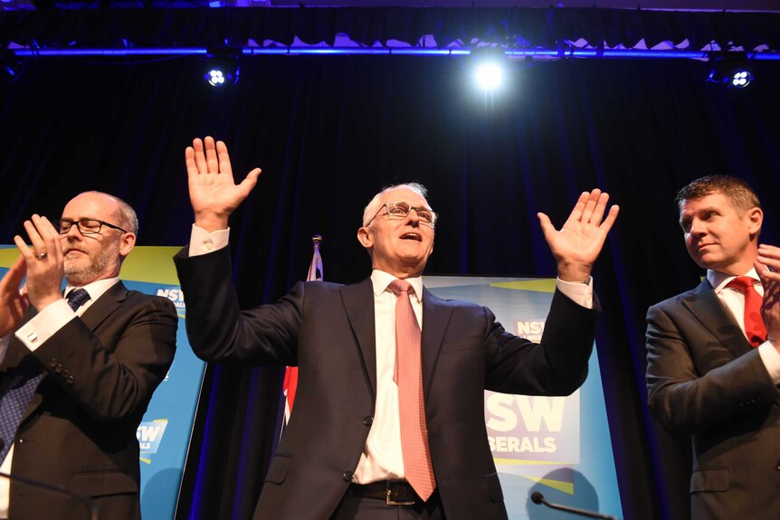 Malcolm Turnbull (centre) with NSW Premier Mike Baird (right) on stage at NSW Liberal State Council