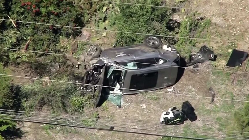 Badly damaged grey car on its side