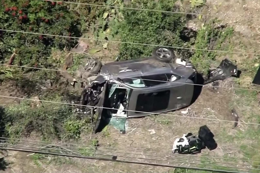 Badly damaged grey car on its side