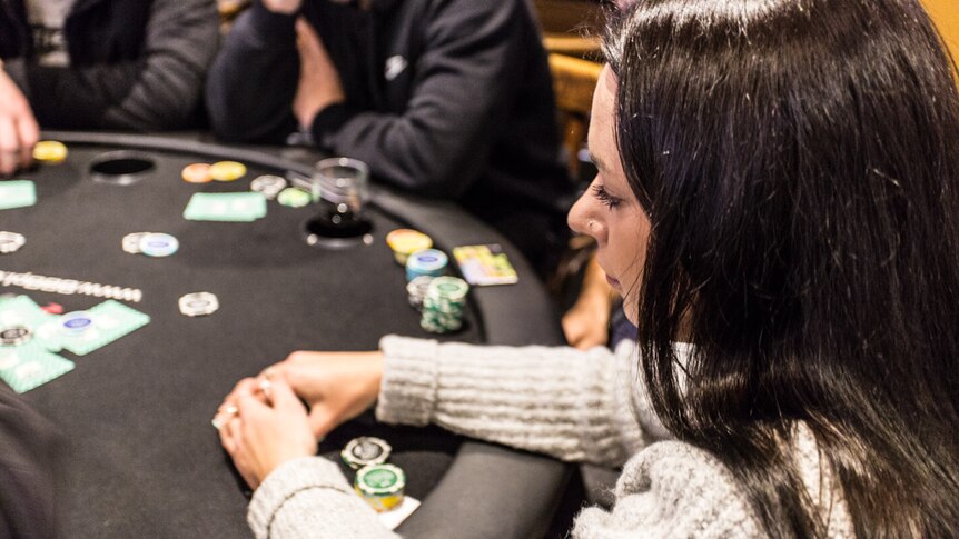 A profile head shot of poker player Mikhala Dower who also has a hearing impairment .