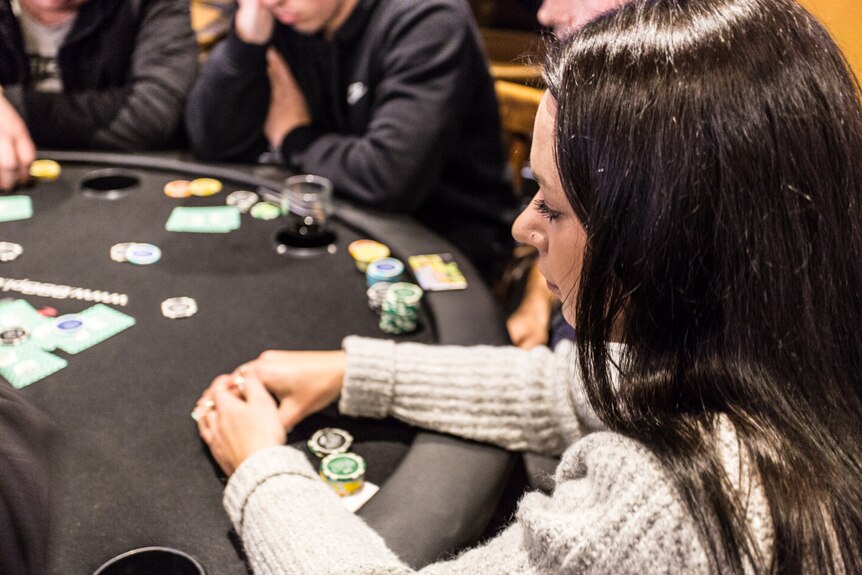 A profile head shot of poker player Mikhala Dower who also has a hearing impairment .