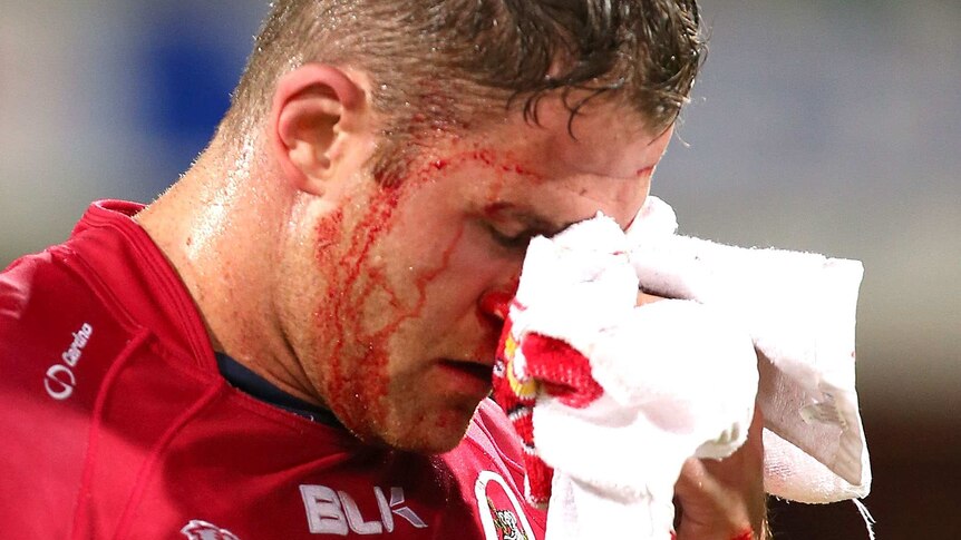 Battle scars ... Reds captain James Horwill Reds leaves the field under the blood rule