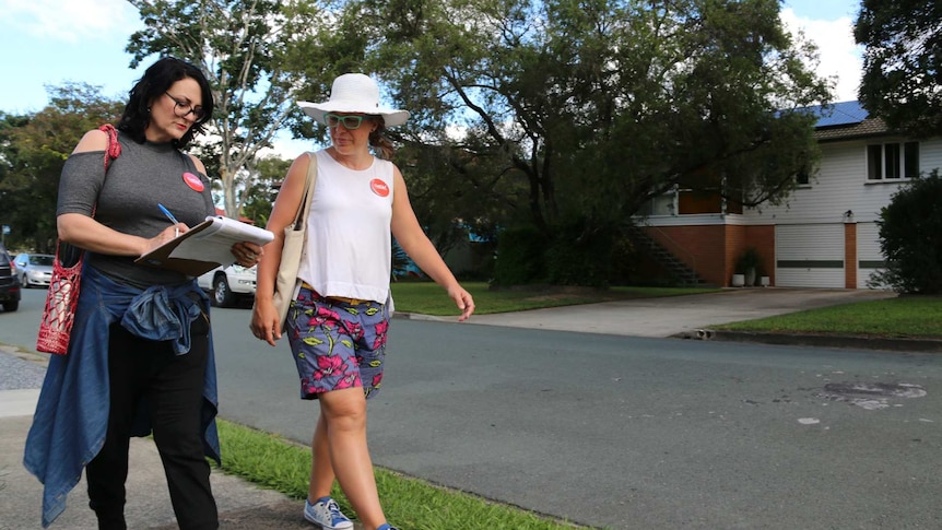 GetUp volunteers Belinda Cox and Trea Ryan walk along a street in the electorate of Dickson.