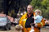 A CFA firefighter spends time with his children at Kinglake