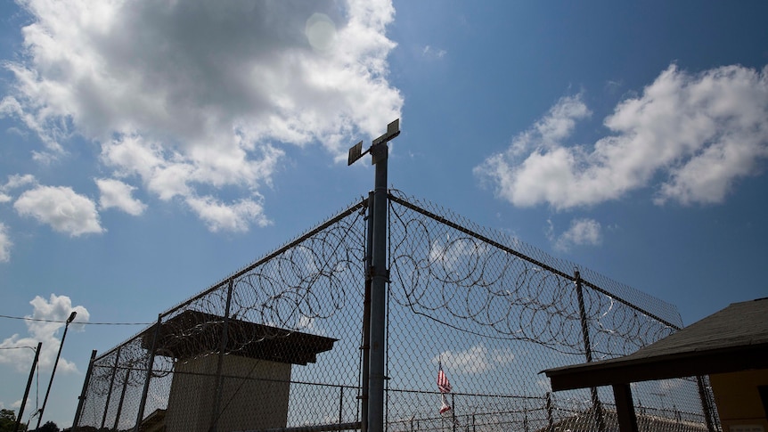 A low angle view of the outside fence of Elmore Correctional Facility at daytime