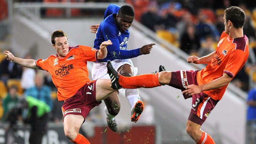 Everton's Victor Anichebe slots the ball past the Roar defence at Lang Park on Saturday night.