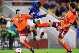 Under pressure...Everton's Victor Anichebe strikes the ball past the Roar defence.