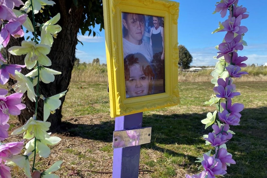 A photo frame with three pictures of Michelle Bright on a cross surrounded by flowers.