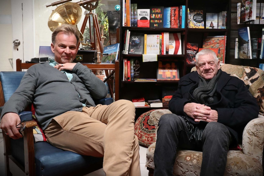 Author Neal Drinnan and Bob Perry sit in Neal's bookshop on low chairs