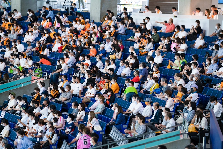 A stadium filled with mask-wearing Japanese people 