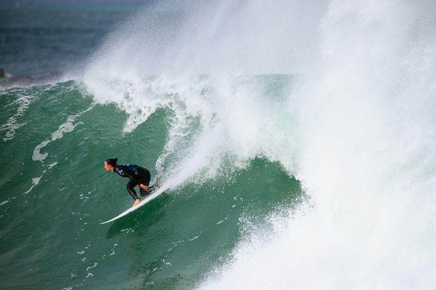 Taylor Wright surfs a wave