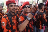 Men in paramilitary uniforms pose for the camera