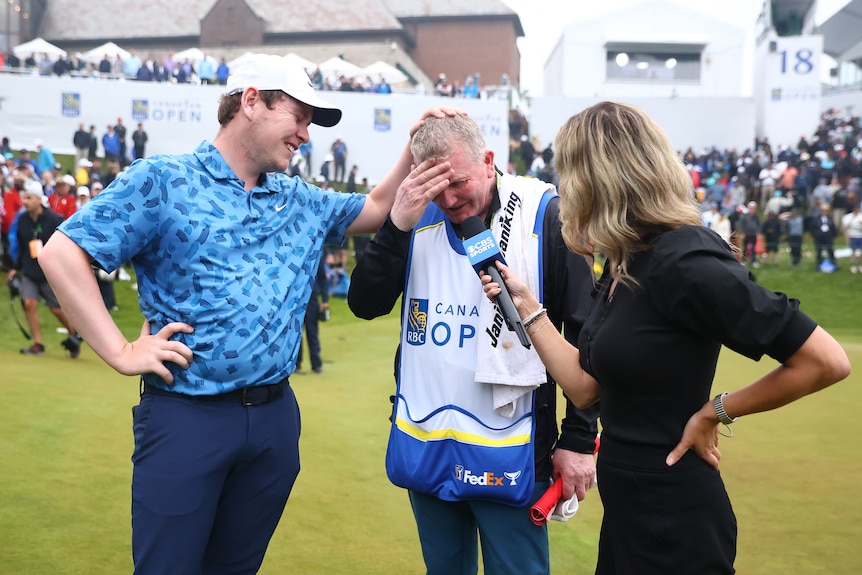 Golfer Robert MacIntyre pats his crying dad and caddy on the head as they are interviewed after the Canadian Open.