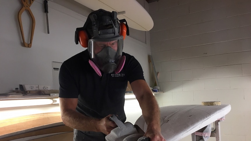 Surfboard maker Bryan Bates at work in his shaping bay in Byron Bay