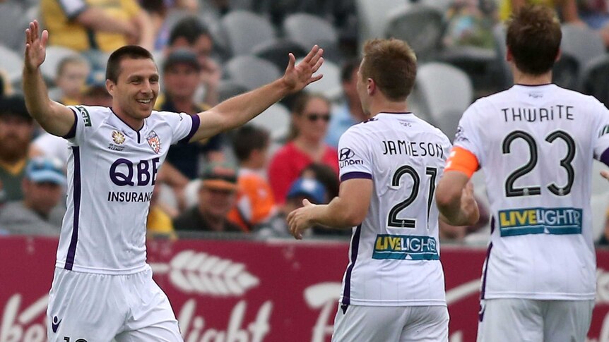 Perth Glory's Nebojsa Marinkjovic (L) celebrates a goal for Perth against Central Coast Mariners.