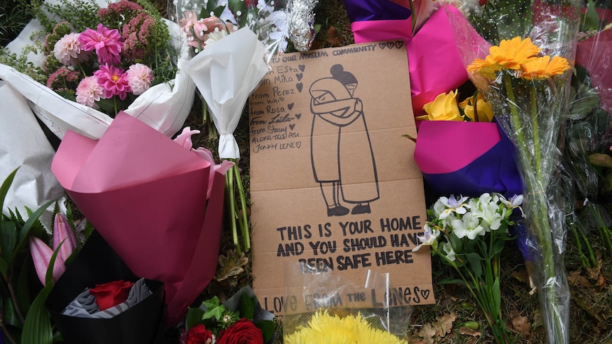 A sign at a memorial on Dean's Avenue in Christchurch reads "This is your home and you should have been safe here".