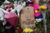 A sign at a memorial on Dean's Avenue in Christchurch reads "This is your home and you should have been safe here".
