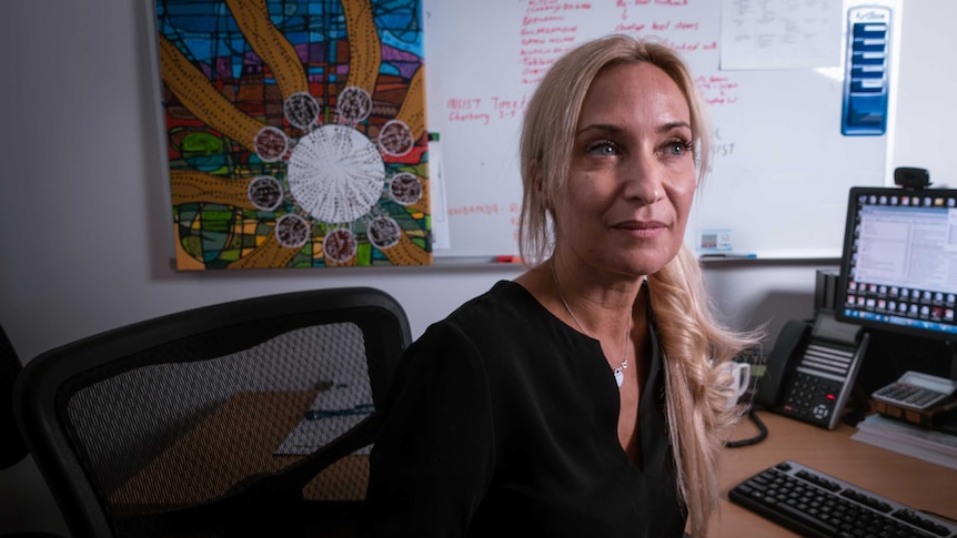 Maree Toombs sits at a desk.