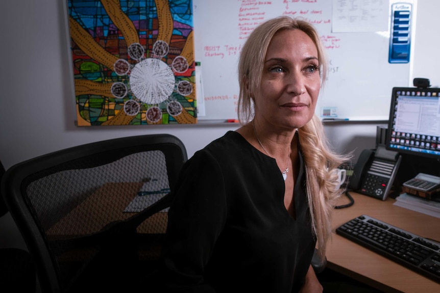 Maree Toombs sits at a desk.