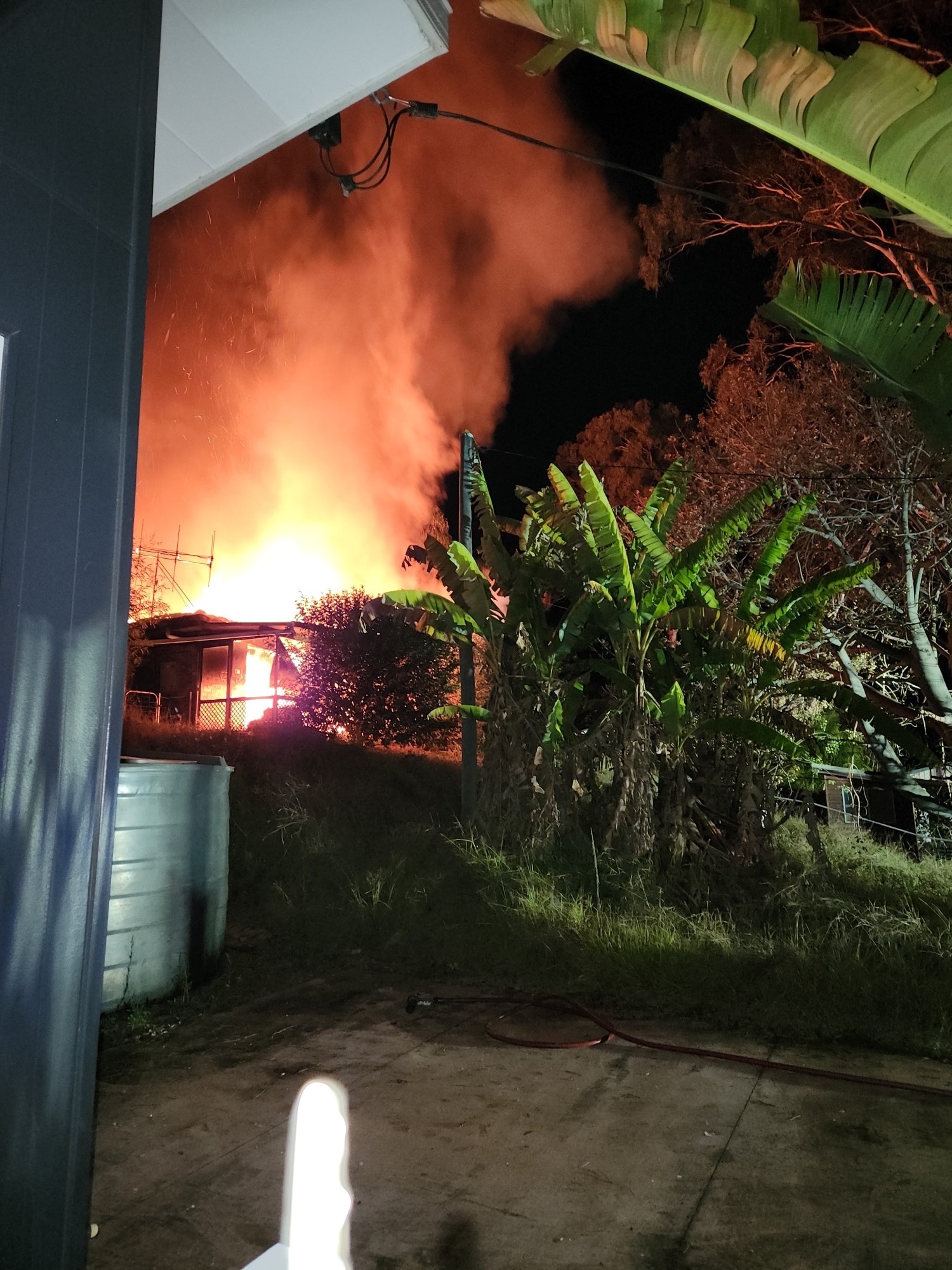 Flames explode through the roof of a home