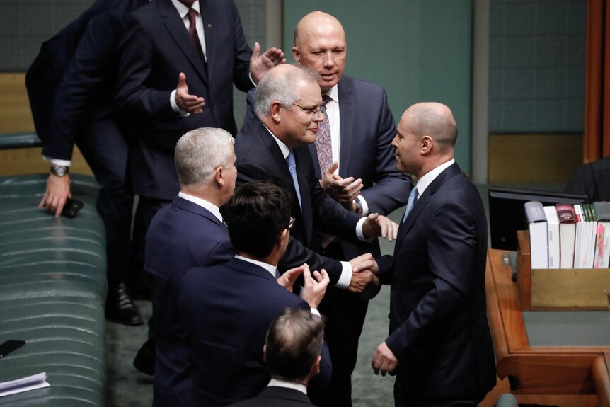 Treasurer Josh Frydenberg shakes hands with Prime Minister Scott Morrison