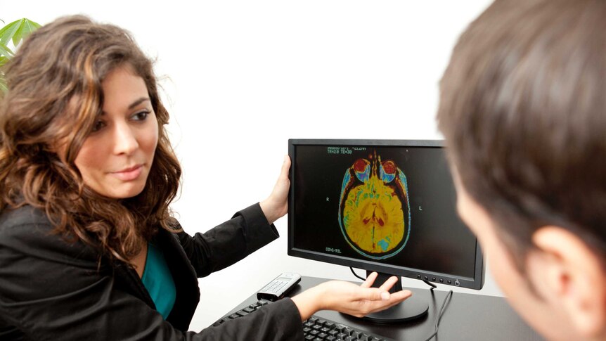 Doctor showing man a brain scan