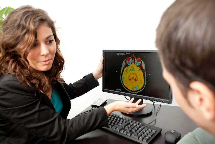 Doctor showing man a brain scan