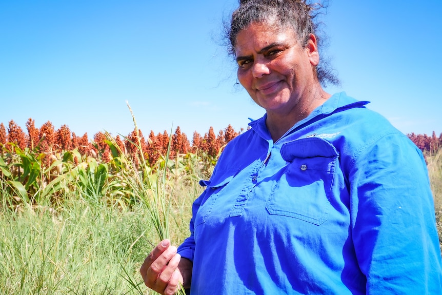 A woman surrounded by grasses.