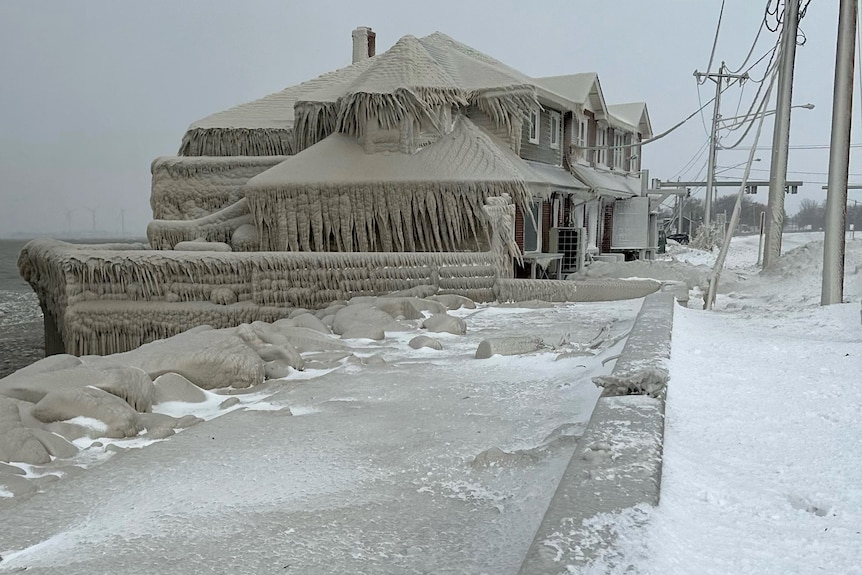 A lakeside restaurant is covered in ice from the spray