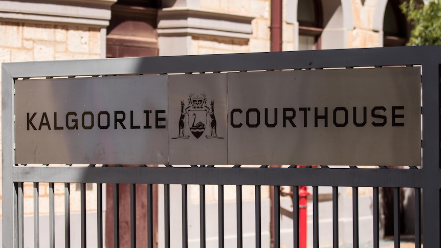 A sign at the entrance to the Kalgoorlie Courthouse displaying the WA coat of arms. 