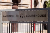 A sign at the entrance to the Kalgoorlie Courthouse displaying the WA coat of arms. 