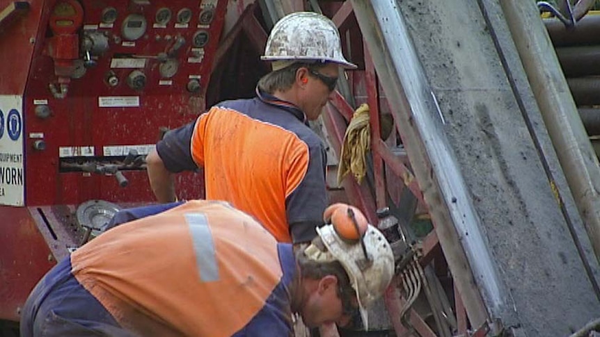 Workers operate a drill on Shree Minerals' site in north-west Tasmania