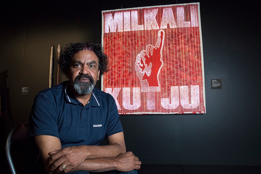 Robert Fielding in front of his artwork on paper, Milkali Kutju at the 2017 NATSIAAs in Darwin.