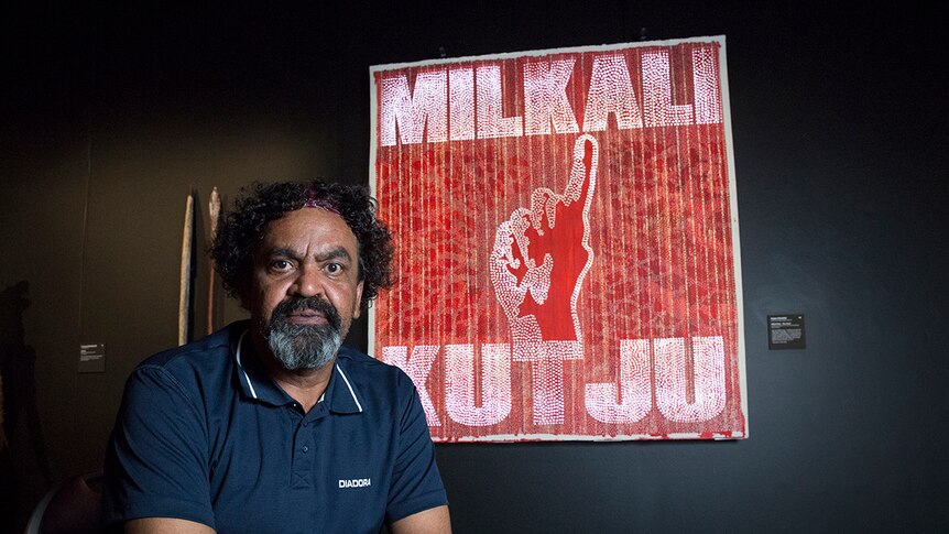 Robert Fielding in front of his artwork on paper, Milkali Kutju at the 2017 NATSIAAs in Darwin.