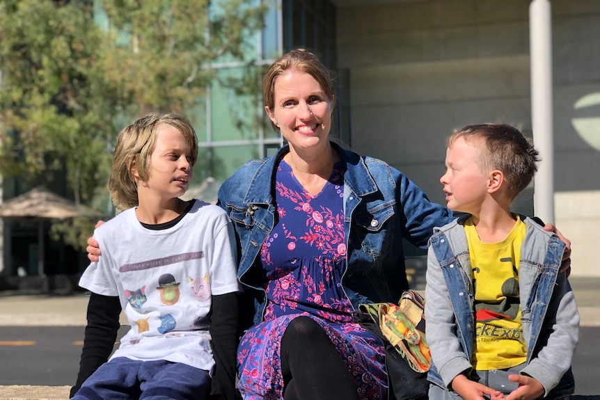 Karen Vincent sits outside the NGA with her sons Noah and Tobey
