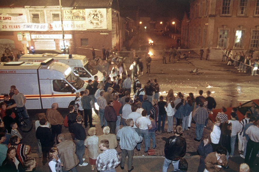 people gather outside the IRA headquarters in Belfast in 1994 after a car bomb exploded