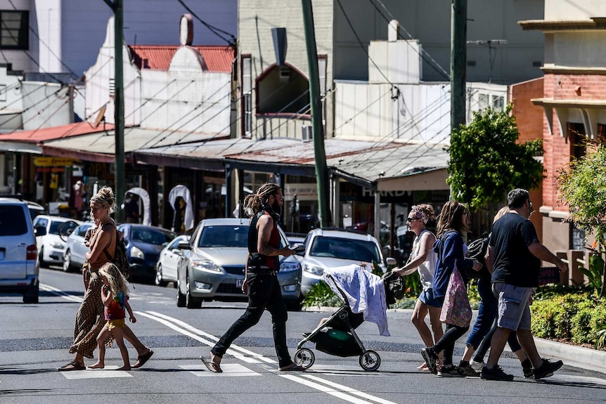 A shot of several people crossing the street.